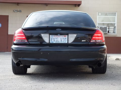 2003 Ford Crown Victoria - Close rear shot of a black Crown Victoria SVT with twin exhaust tips and EVIL VIC California plate.