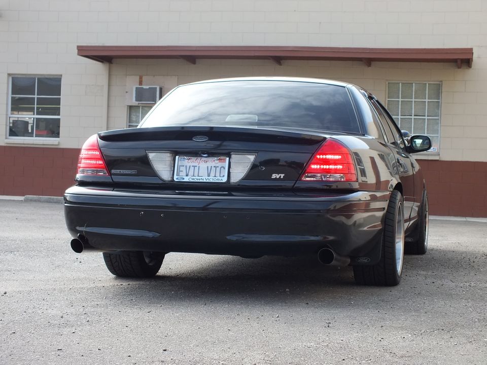 Black Crown Victoria SVT rear three-quarter with EVIL VIC plate and dual exhaust