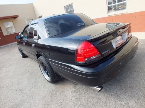 2003 Ford Crown Victoria - Rear three-quarter of a black Crown Victoria SVT on chrome wheels with a polished exhaust tip.