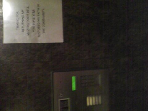 2003 Ford Crown Victoria - A note is attached to a wall near a doorbell panel.