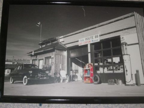 1991 Ford LTD Crown Victoria - A classic car sits in front of a historic Route 66 gas station and museum.