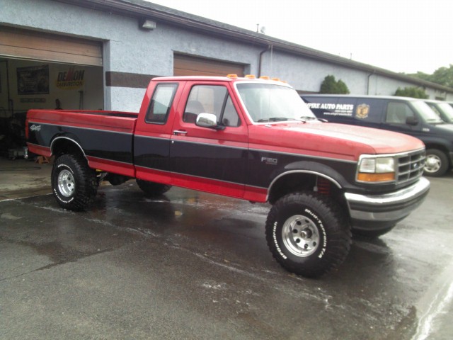 1993 Ford F-150 pickup truck, red and black, 3q-front view