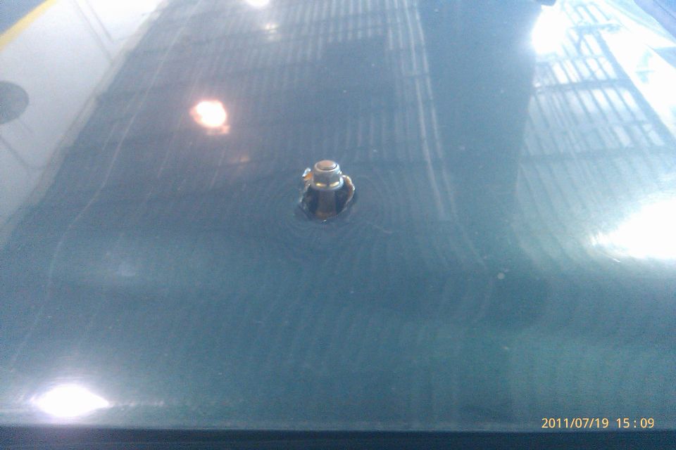 Antenna base mount on a dark colored car hood