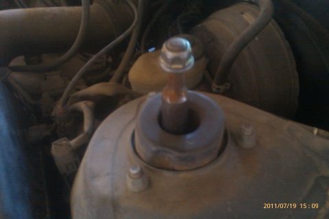 2000 Mercury Grand Marquis - The image shows a close-up view of a vehicle's engine compartment, focusing on a suspension strut mount.