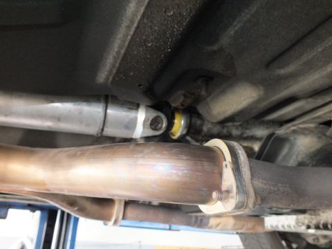 2003 Ford Crown Victoria - U-joint and support bearing meet a polished crossover pipe in this undercarriage angle.