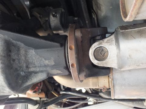 2003 Ford Crown Victoria - Pinion flange and U-joint yoke joined at the differential, viewed from beneath.
