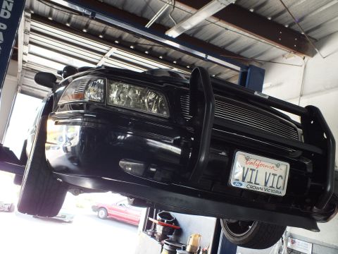 2003 Ford Crown Victoria - Brush guard and California plate reading VIL VIC on the front of the lifted Crown Victoria.