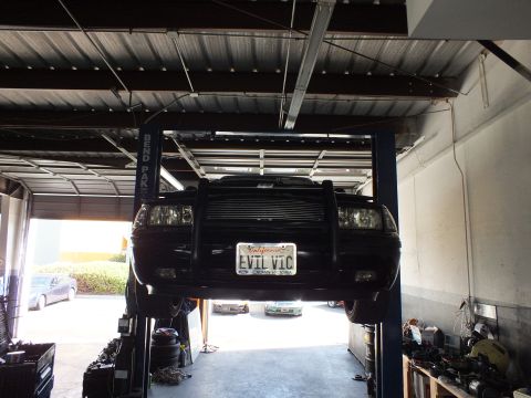 2003 Ford Crown Victoria - Front view of the lifted black Crown Victoria showing its EVIL VIC California plate.