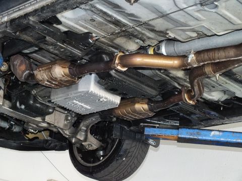 2003 Ford Crown Victoria - Close undercarriage shot of transmission, catalytic converters and exhaust on a hoisted vehicle.