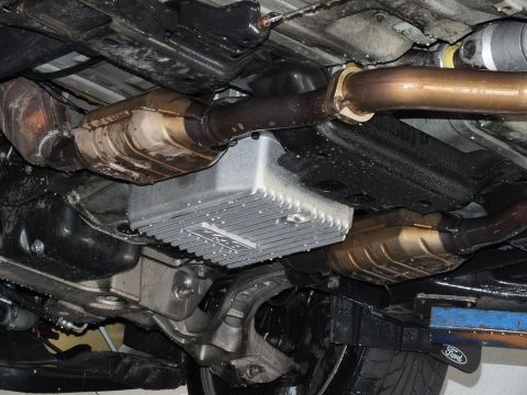 2003 Ford Crown Victoria - Detailed undercarriage shot showing converters, transmission pan and exhaust routing.