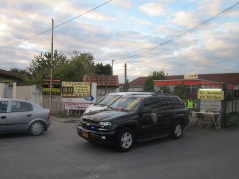 1991 Ford LTD Crown Victoria - A black SUV, possibly an official vehicle, is parked on a street next to a silver car.