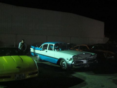 1991 Ford LTD Crown Victoria - A classic two-tone sedan with prominent fins is parked outdoors at night.