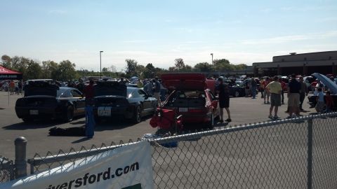2007 Ford Mustang - An outdoor car show with many vehicles on display under a clear sky.