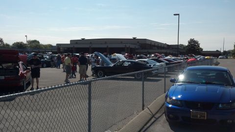 2007 Ford Mustang - A blue 2004 Ford Mustang Cobra is parked at a car show with other vehicles.