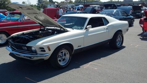 2007 Ford Mustang - A white 1970 Ford Mustang is displayed with its hood open at an outdoor event, surrounded by other vehicles.