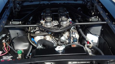2007 Ford Mustang - Close-up of a V8 engine bay with custom modifications and visible plumbing.