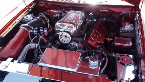 2007 Ford Mustang - Custom engine bay features a polished supercharger and red intake system.