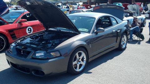 2007 Ford Mustang - A gray Ford Mustang Cobra is displayed with its hood open at an outdoor car show.