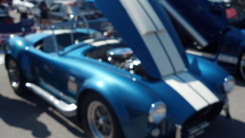 2007 Ford Mustang - Blue convertible sports car with hood open at a car show, with another vehicle in the background.