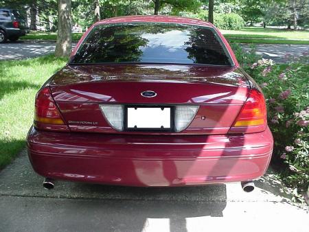 2002 Ford Crown Victoria - Rear view of a red 2002 Ford Crown Victoria LX sedan parked outdoors.