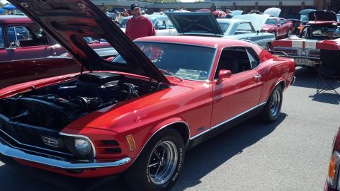 2007 Ford Mustang - A red 1970 Ford Mustang is displayed at a car show with its hood open.