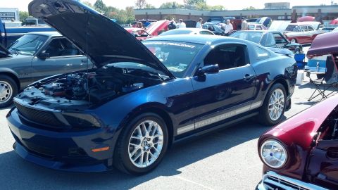 2007 Ford Mustang - Blue 2007 Ford Mustang coupe at a car show, hood open revealing the engine bay.