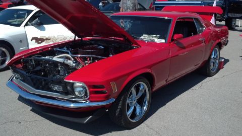 2007 Ford Mustang - A bright red 1970 Ford Mustang coupe is displayed with its hood open, the engine and custom chrome wheels.