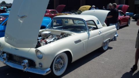 2007 Ford Mustang - A white 1955 Ford Thunderbird convertible is displayed with its hood open at a car show.