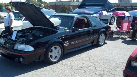 2007 Ford Mustang - A black 1987 Ford Mustang 5.0 is displayed with its hood and trunk open at a car show.