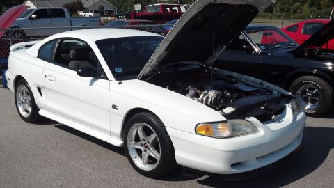 2007 Ford Mustang - White 1996 Ford Mustang coupe parked outdoors with its hood raised, showing the engine bay.