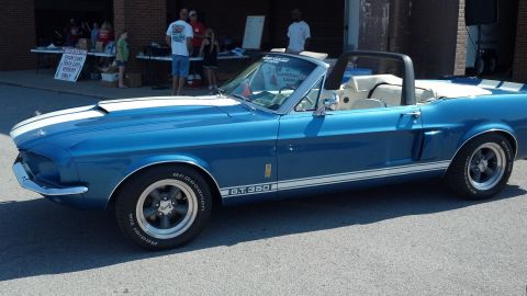 2007 Ford Mustang - A classic blue 1967 Ford Mustang convertible is displayed at an outdoor car show.