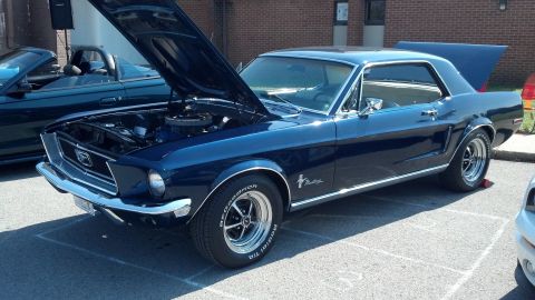 2007 Ford Mustang - A dark blue 1967 Ford Mustang coupe is displayed with its hood and trunk open at an outdoor car show.