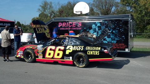 2007 Ford Mustang - A race car with the number 66 and "Price's Collision Centers" branding is displayed next to a trailer.