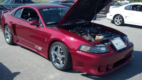 2007 Ford Mustang - Red Saleen Mustang with hood open at a car show, with another Mustang visible in the background.