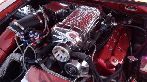 2007 Ford Mustang - Close-up view of a modified engine bay, highlighting a polished supercharger and custom components.