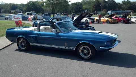 2007 Ford Mustang - A blue 1967 Ford Mustang GT350 convertible is parked at a car show with other Mustangs in the background.