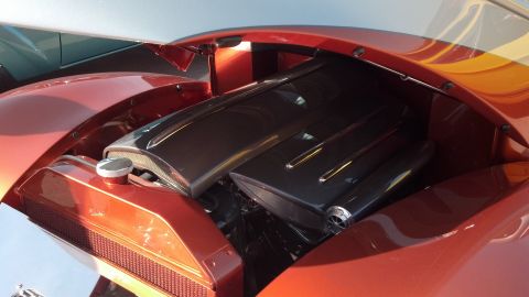 2007 Ford Mustang - Close-up of a custom hot rod's engine bay, unique paint and polished components.
