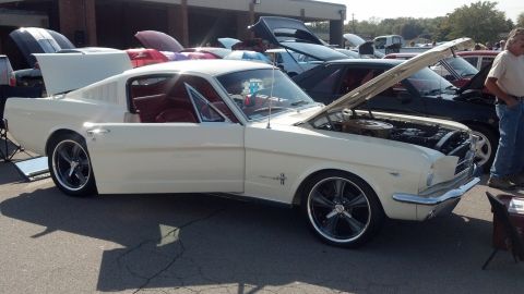 2007 Ford Mustang - A classic 1965 Ford Mustang coupe is displayed with its hood and trunk open at a car show.