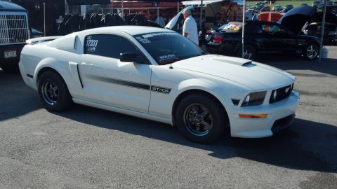 2007 Ford Mustang - A white Ford Mustang GT/CS with racing modifications is parked at an outdoor event.