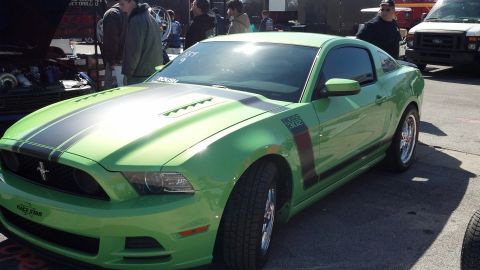 2007 Ford Mustang - A lime green Ford Mustang with racing stripes and a 'BOSS 302' decal is parked outdoors.