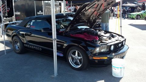 2007 Ford Mustang - A black 2007 Ford Mustang convertible is displayed with its hood open, revealing the engine and "Brenspped" branding on the side.