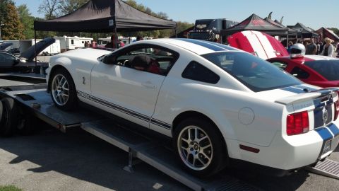 2007 Ford Mustang - White 2007 Ford Mustang Shelby GT500 being loaded onto a car hauler at an event.