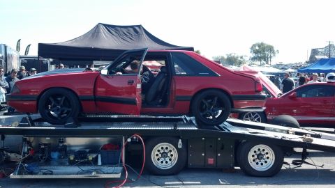 2007 Ford Mustang - Red fox body Mustang coupe being transported on a car hauler with another Mustang in the background.