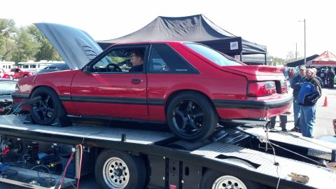 2007 Ford Mustang - A red 1987 Ford Mustang is on a trailer with its hood open, likely at a car show or event.
