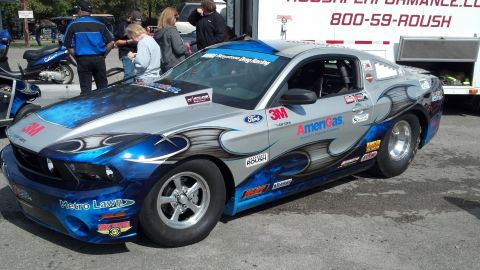 2007 Ford Mustang - A customized Ford Mustang, likely modified for drag racing, is parked outdoors with a trailer in the background.
