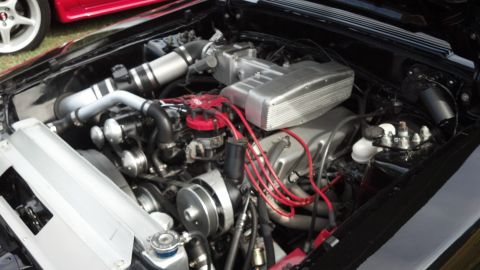 2007 Ford Mustang - Close-up view of a modified V8 engine bay, showing intake and ignition components.