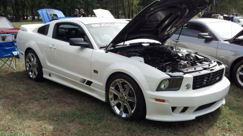 2007 Ford Mustang - A white 2007 Ford Mustang Saleen is displayed with its hood open at an outdoor car show.