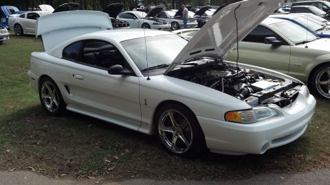 2007 Ford Mustang - A white 1994 Ford Mustang is displayed with its hood open at an outdoor car show.
