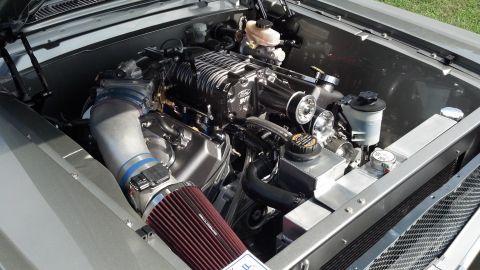 2007 Ford Mustang - Close-up view of a highly modified V8 engine, a prominent supercharger and custom intake system.