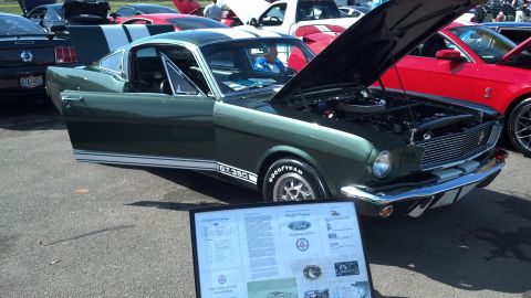2007 Ford Mustang - A classic 1965 Ford Mustang GT350 is displayed with its hood and door open at an event.